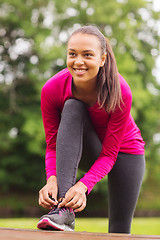 Image showing smiling woman exercising outdoors