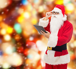 Image showing man in costume of santa claus with tablet pc