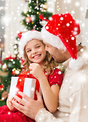 Image showing smiling father and daughter holding gift box