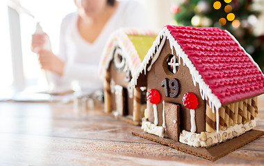 Image showing close up of woman making gingerbread houses