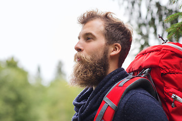 Image showing smiling man with beard and backpack hiking