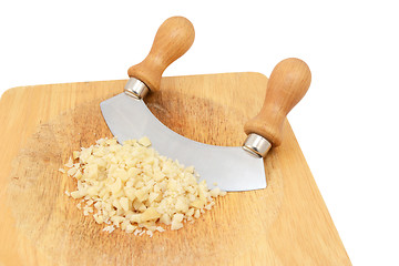 Image showing Finely chopped macadamia nuts with a rocking knife