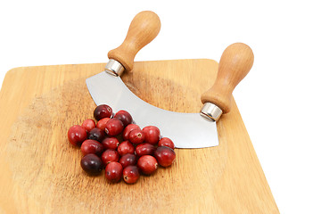 Image showing Whole fresh cranberries with a rocking knife