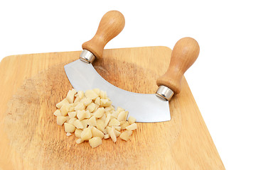 Image showing Coarsely chopped macadamia nuts with a rocking knife