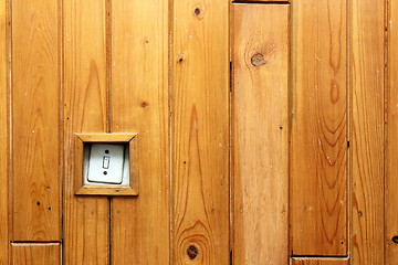 Image showing old electric switch on wooden wall