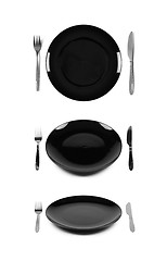 Image showing Black plate with fork and knife.