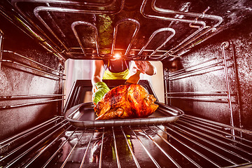 Image showing Cooking chicken in the oven at home.