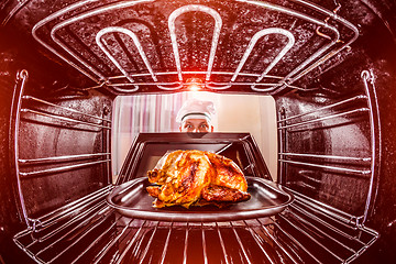 Image showing Cooking chicken in the oven.