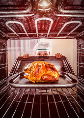 Image showing Cooking chicken in the oven.