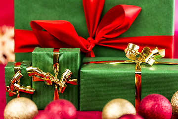 Image showing Four Xmas Presents with Bows in Gold and Red