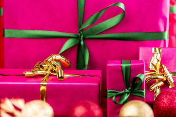 Image showing Four Xmas Presents Wrapped in Plain Magenta