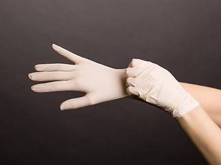 Image showing Putting on latex gloves