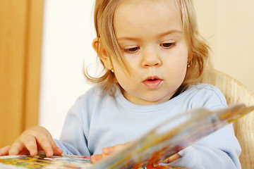 Image showing Small baby reading a book