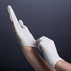 Image showing Putting on latex gloves