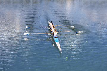 Image showing Four men rowing 