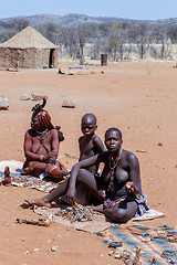 Image showing Himba and Zemba girl with souvenirs for sale in traditional vill