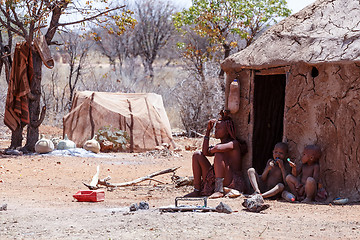 Image showing Himba woman with childs on the neck in the village