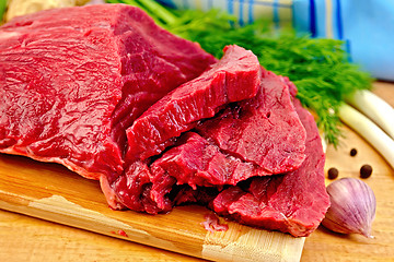 Image showing Meat beef with herbs on wooden board