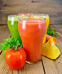 Image showing Juice tomato and vegetables in glasses on board