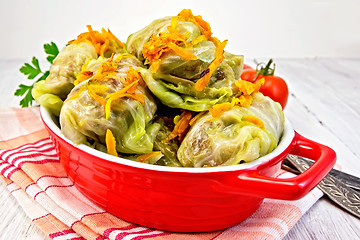 Image showing Cabbage stuffed and carrots in pan on board