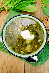 Image showing Soup green of sorrel and spinach with sour cream on board