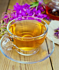 Image showing Tea from fireweed in glass cup on board