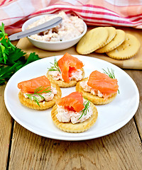 Image showing Crackers with cream and salmon in plate on board