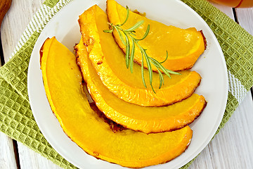 Image showing Pumpkin baked with honey in plate on light board