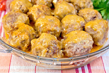 Image showing Meatballs with sauce in glass pan on tablecloth