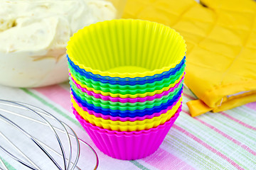 Image showing Molds for cupcakes with potholder mixer on fabric