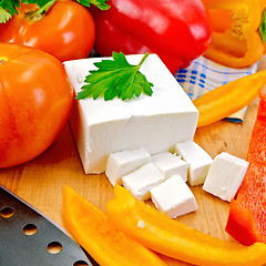 Image showing Feta with vegetables and herbs on wooden board