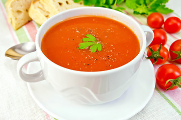 Image showing Soup tomato with peppers in bowl on linen napkin