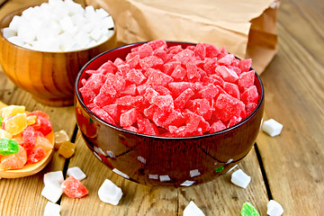 Image showing Candied fruit colored in bowl and spoon on board