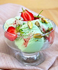 Image showing Ice cream strawberry-pistachio on napkin and board