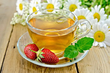 Image showing Tea with strawberries and daisies on board