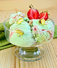 Image showing Ice cream strawberry-pistachio with napkin on board