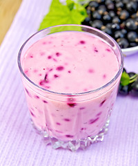 Image showing Milkshake with blackcurrants on purple napkin