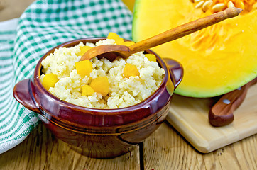 Image showing Porridge millet with pumpkin and wooden spoon