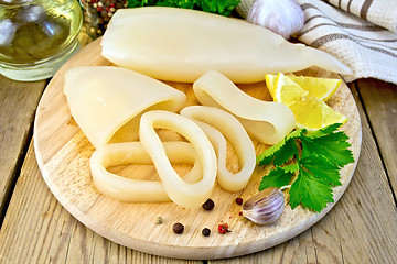 Image showing Calamari with lemon and garlic on board