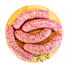 Image showing Sausages pork with rosemary on round board