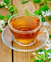Image showing Tea with white flowers of honeysuckle on board