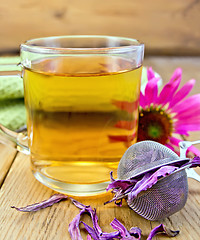 Image showing Tea from Echinacea in glass mug with strainer on board