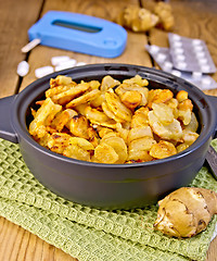 Image showing Jerusalem artichokes roasted in pan with meter and pills