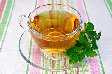 Image showing Tea with mint in cup on napkin