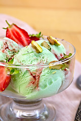 Image showing Ice cream strawberry-pistachio on napkin