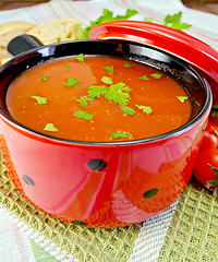 Image showing Soup tomato in red ware on napkin