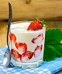 Image showing Yogurt thick with strawberries and leaves on board