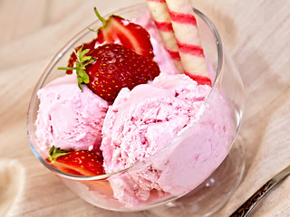 Image showing Ice cream strawberry in glass bowl with waffles on fabric