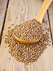 Image showing Buckwheat in wooden spoon on board