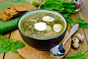 Image showing Soup green of sorrel and nettle with quail eggs